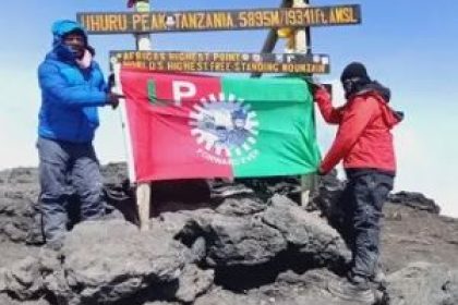 At the top of Mount Kilimanjaro, a Tanzanian flies the flag of the Labor Party. Afro News Wire